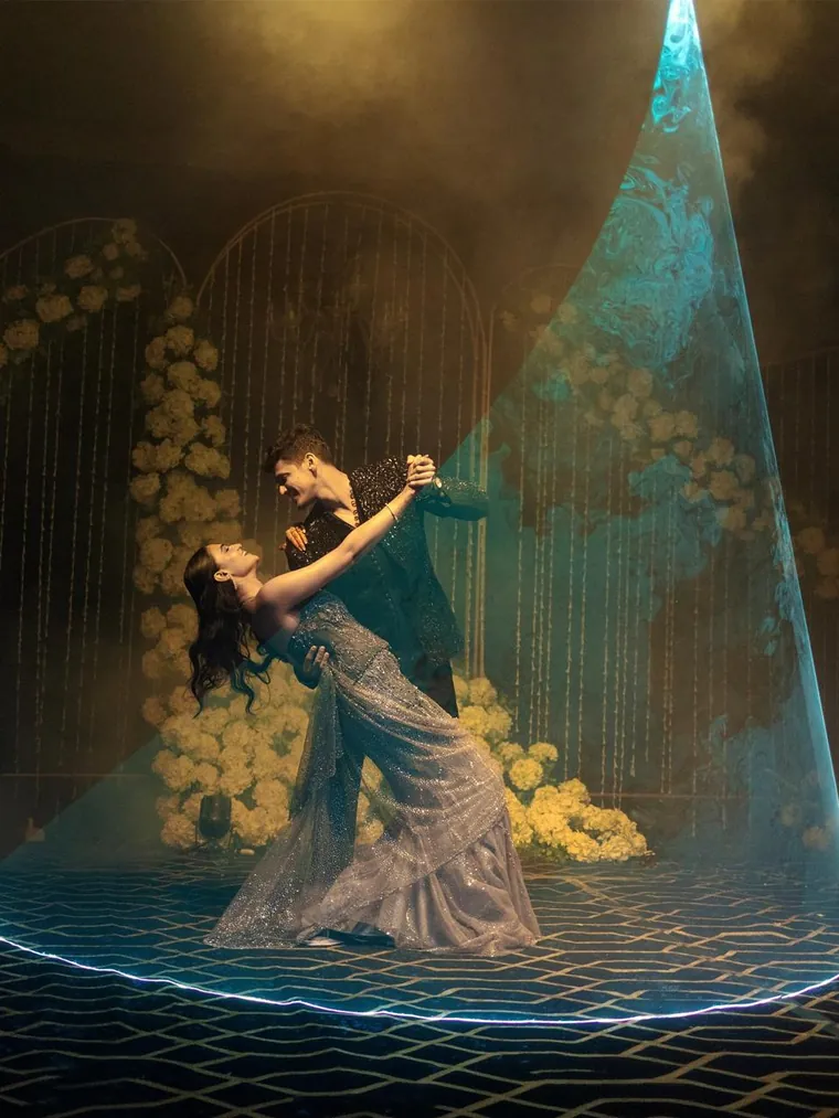 A couple performing their first dance under a spotlight